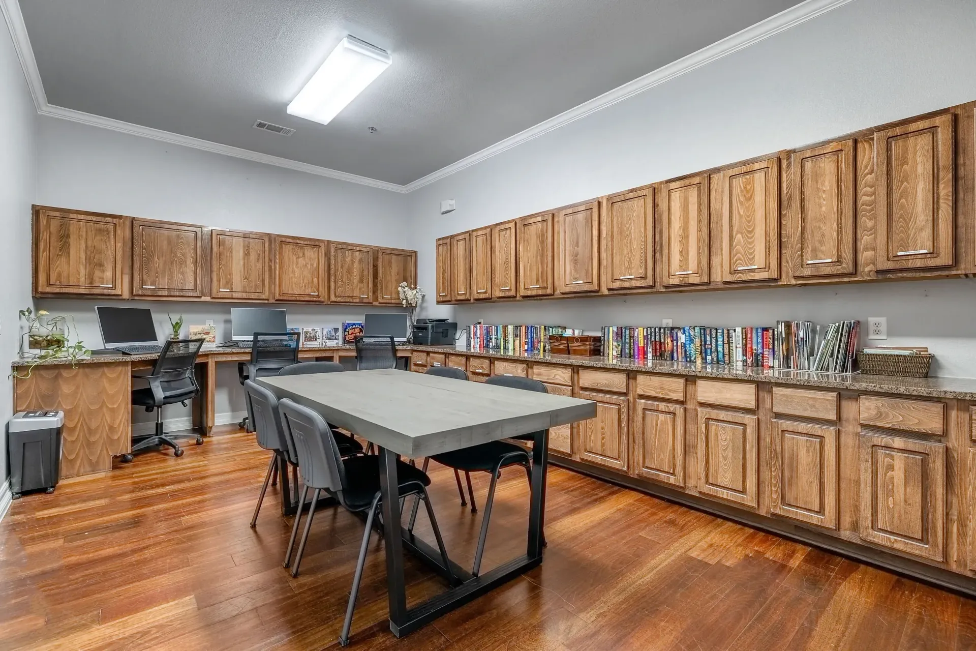 Community business center with computers, a conference table, and bookshelves.