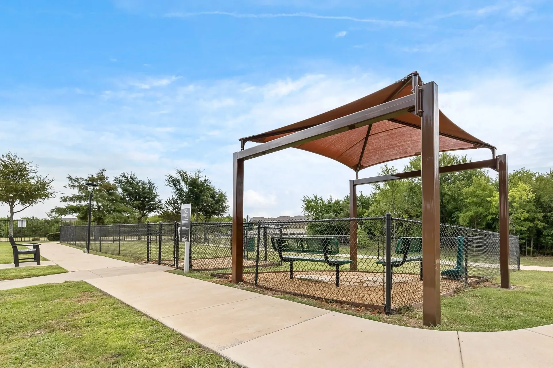 Dog park with covered seating and benches.