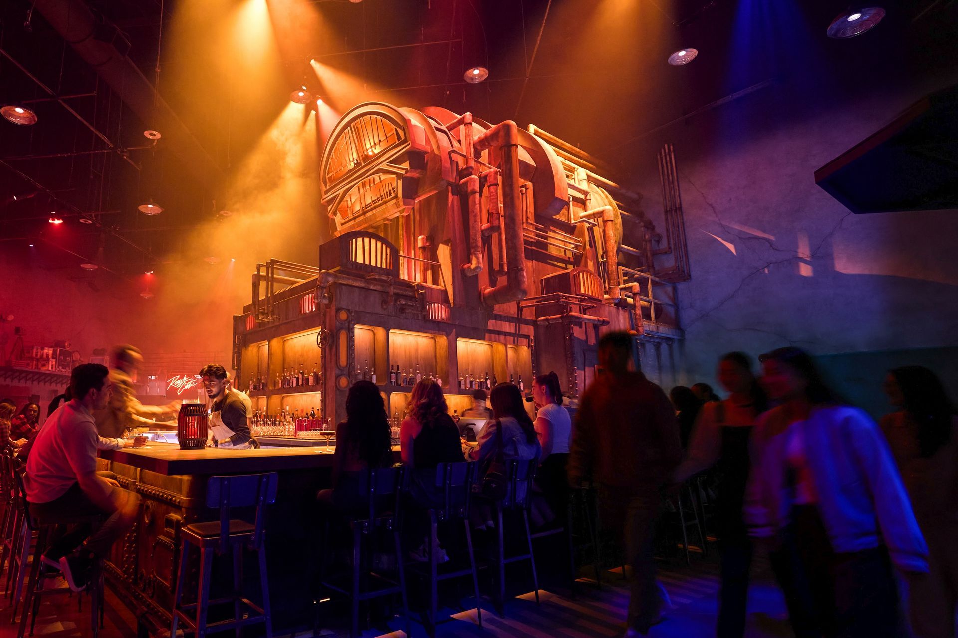 Bar scene, steampunk decor, colorful lighting. People at the bar, large mechanical backdrop.