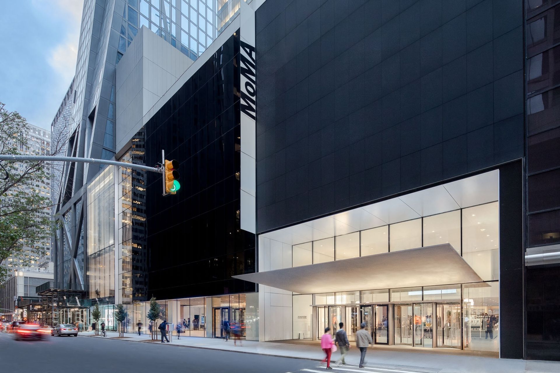 Exterior of the Museum of Modern Art (MoMA) in New York City; black building facade and glass entrance.