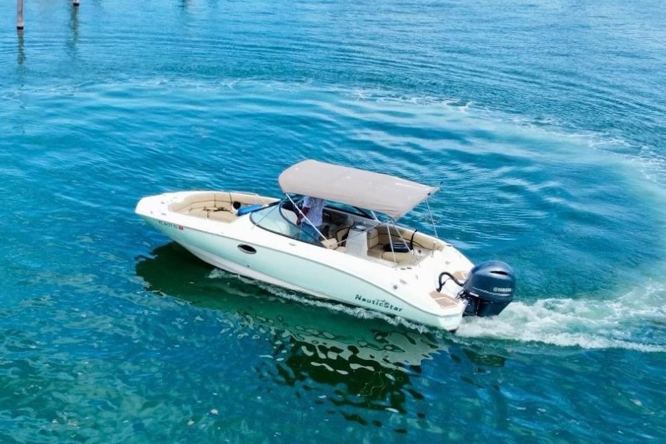 White motorboat on turquoise water, underway.