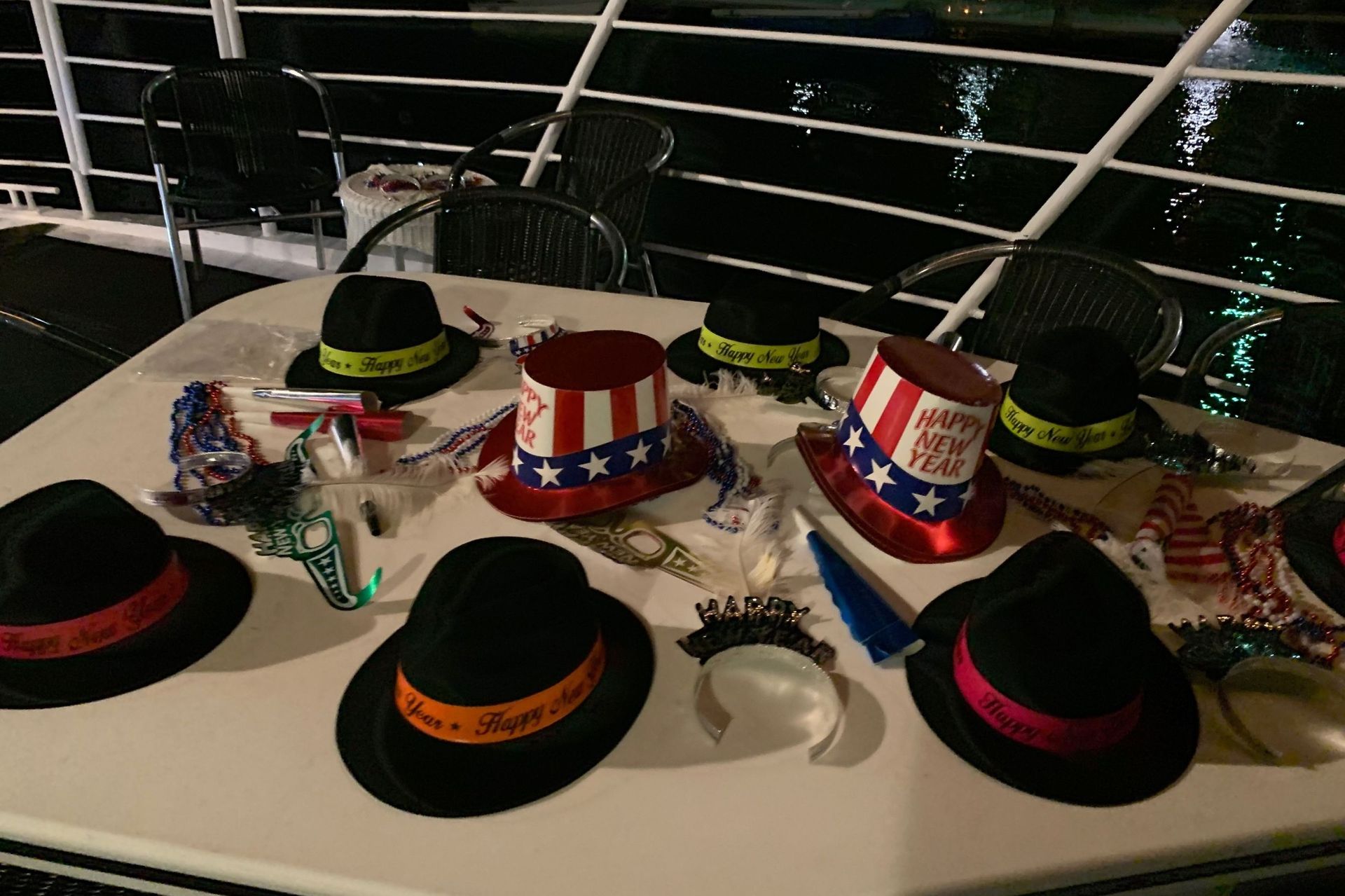 Hats and party favors on a table. Includes top hats, star-spangled hats, and other celebratory items.