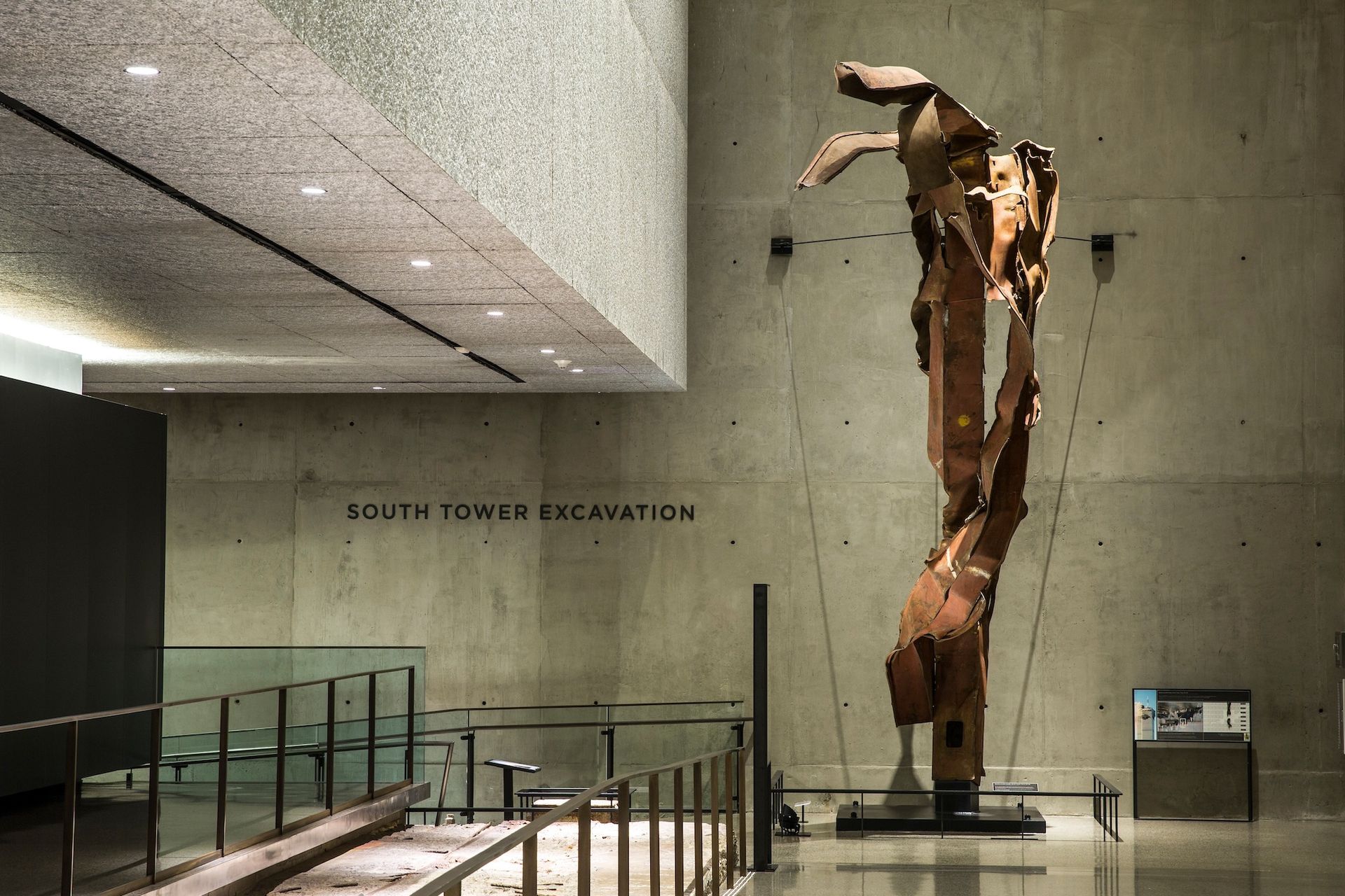A twisted, bronze beam sculpture stands in the 9/11 Memorial Museum. 