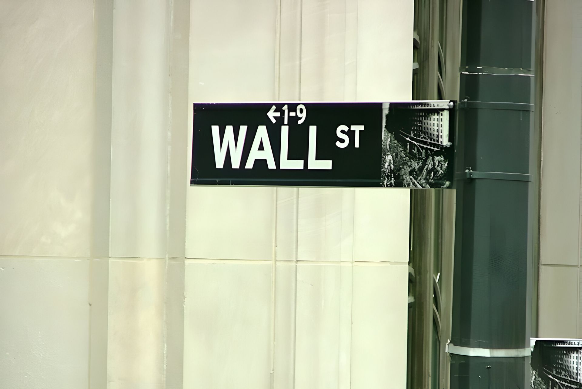 Wall Street street sign, black and white, addresses 1-9.