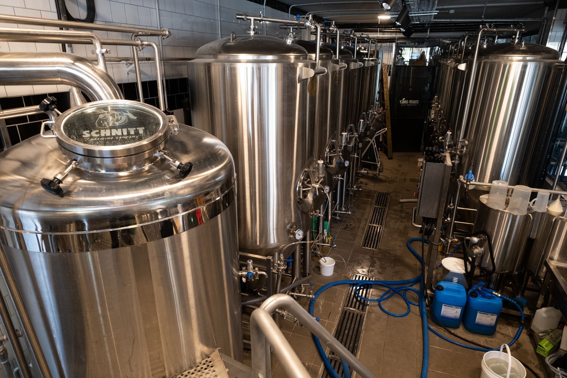 Brewery with stainless steel tanks and equipment.