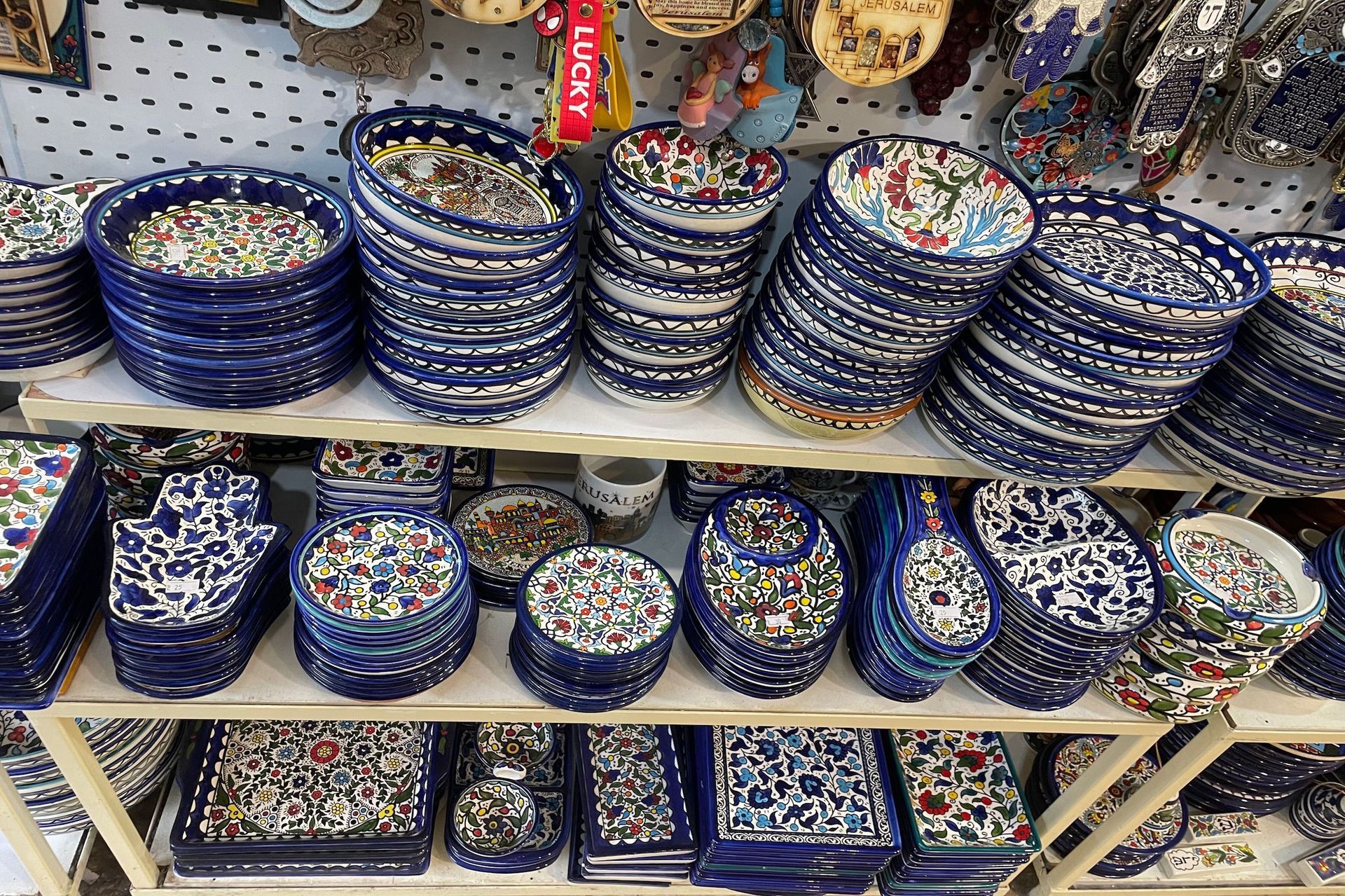 Shelves filled with blue and white ceramic plates and bowls with floral designs.