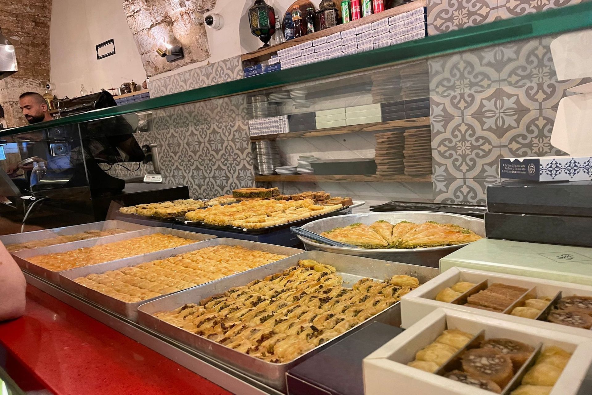 Display case with rows of baklava pastries at a shop.