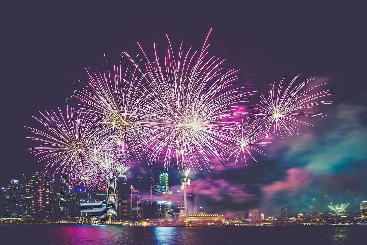 Fireworks over the Miami skyline from the water.