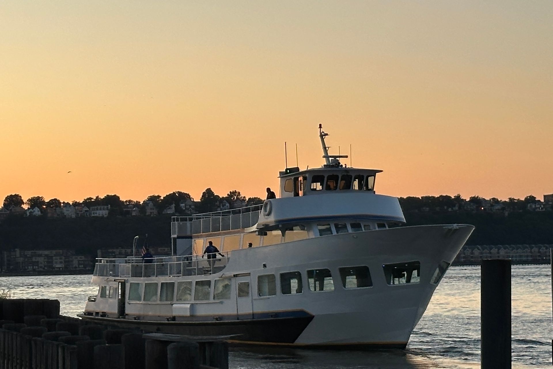 White passenger ferry on water at sunset.