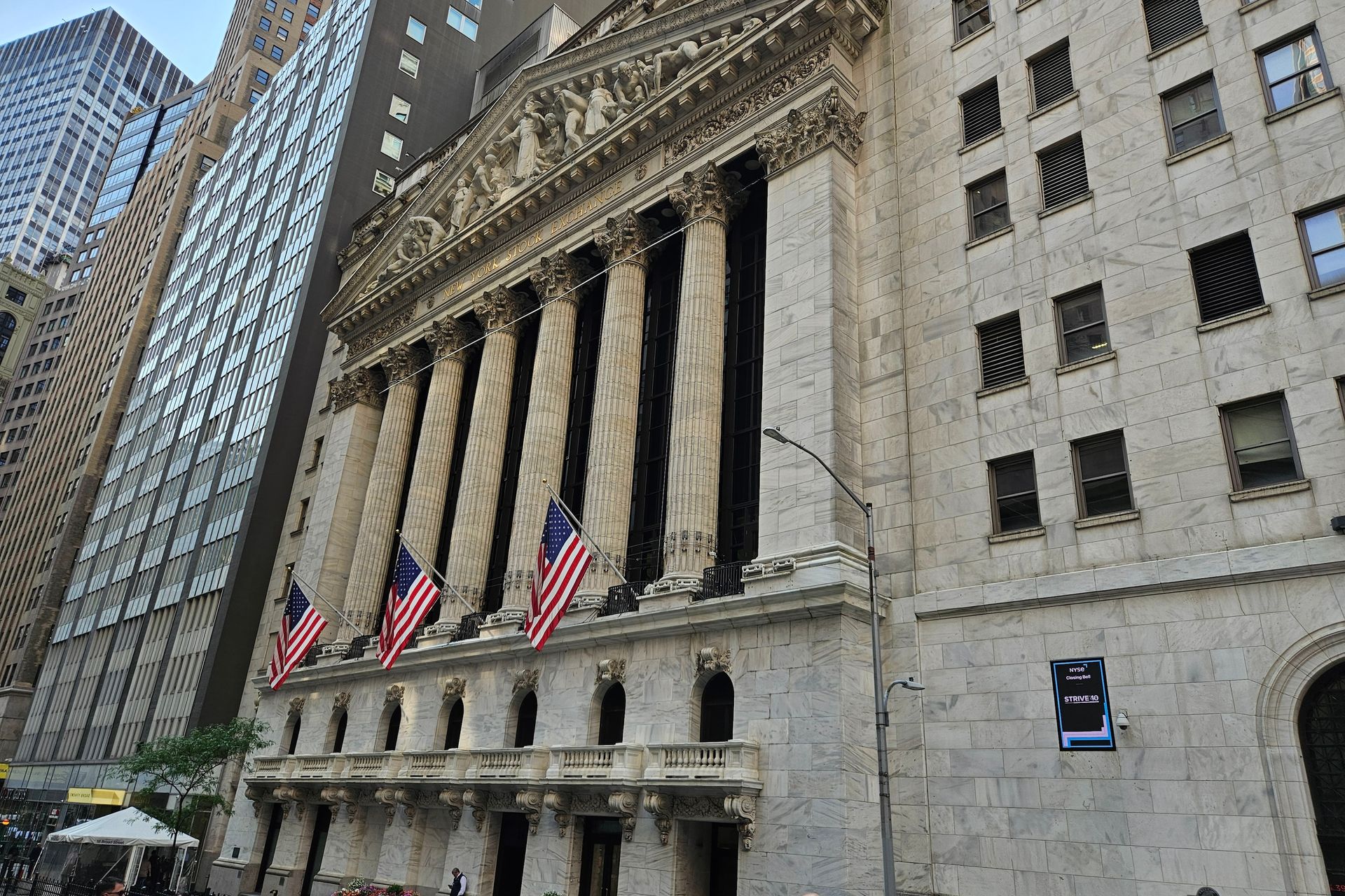 New York Stock Exchange building with American flags.