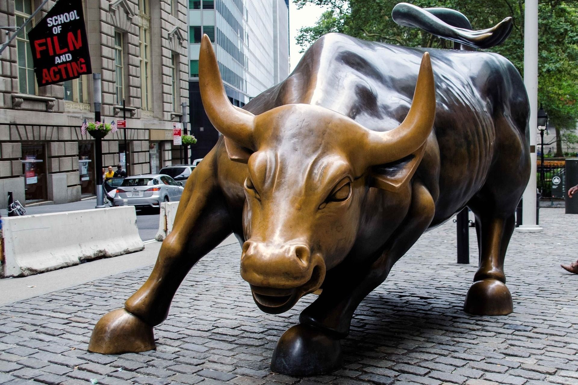 Bronze Charging Bull statue in New York City, a symbol of financial optimism.