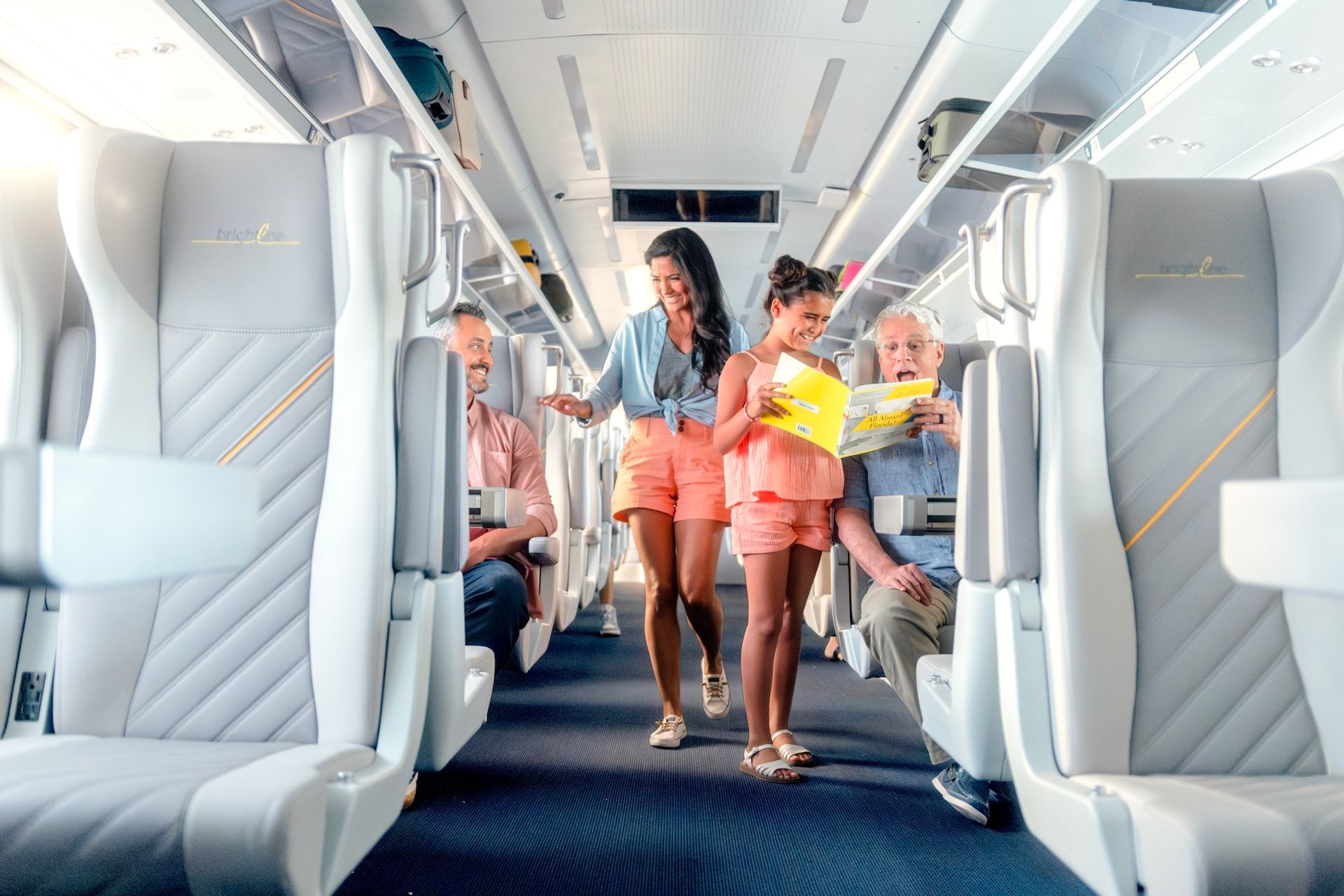 Inside a bright bus: Woman and girl walk, map in hand. Passengers seated, neutral tones.
