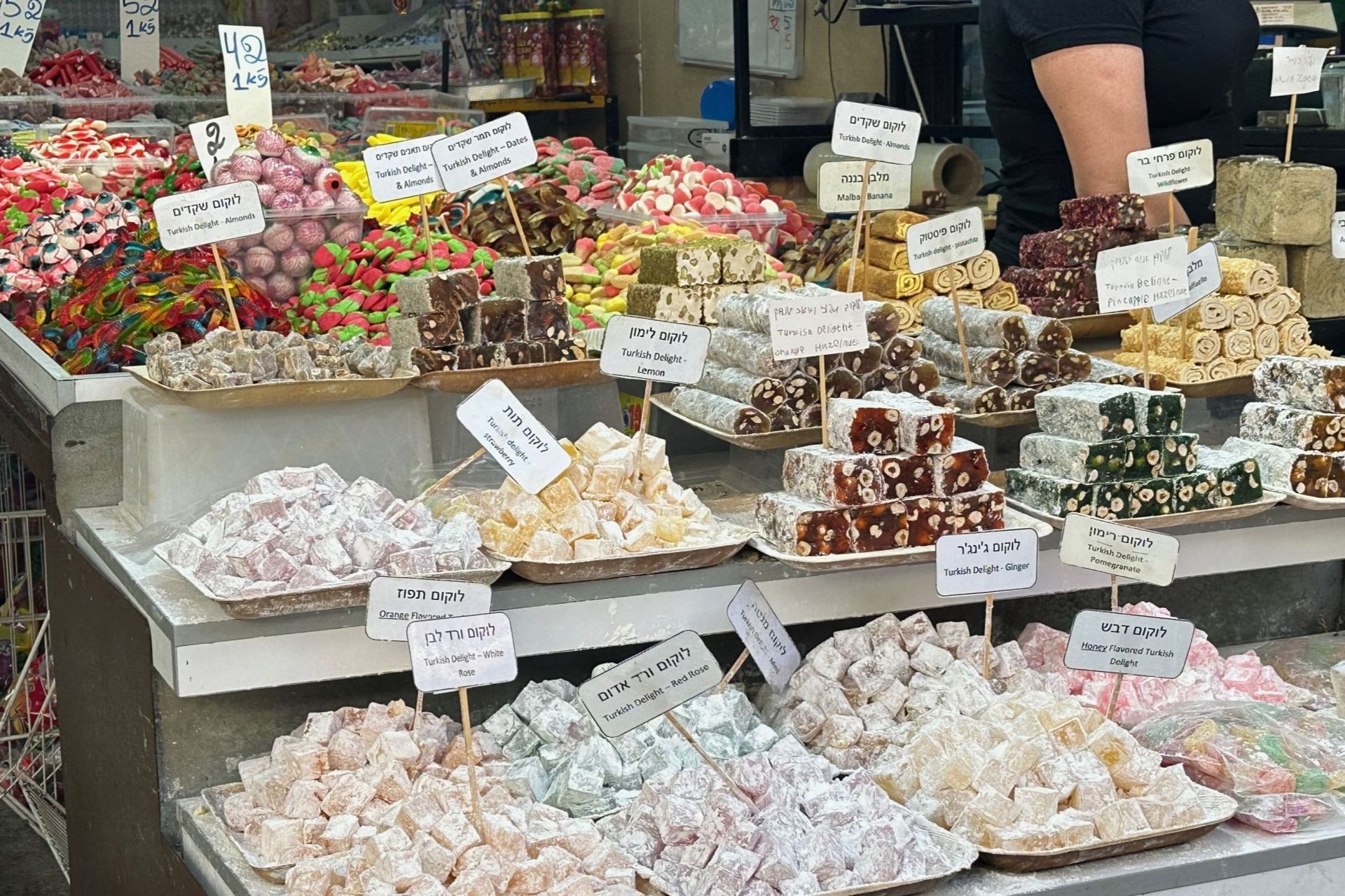 A candy store display showcasing colorful Turkish delights, various flavors, and textures.