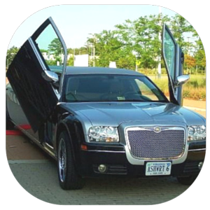 Black luxury sedan with gull-wing doors open, parked outdoors on a sunny day.