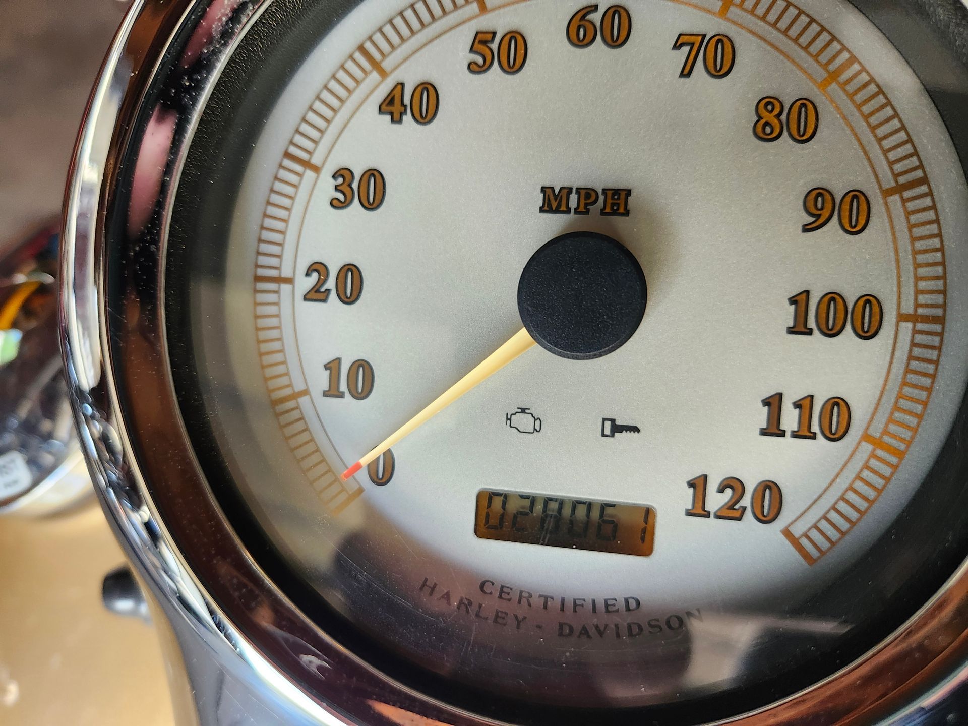 A close up of a harley davidson speedometer
