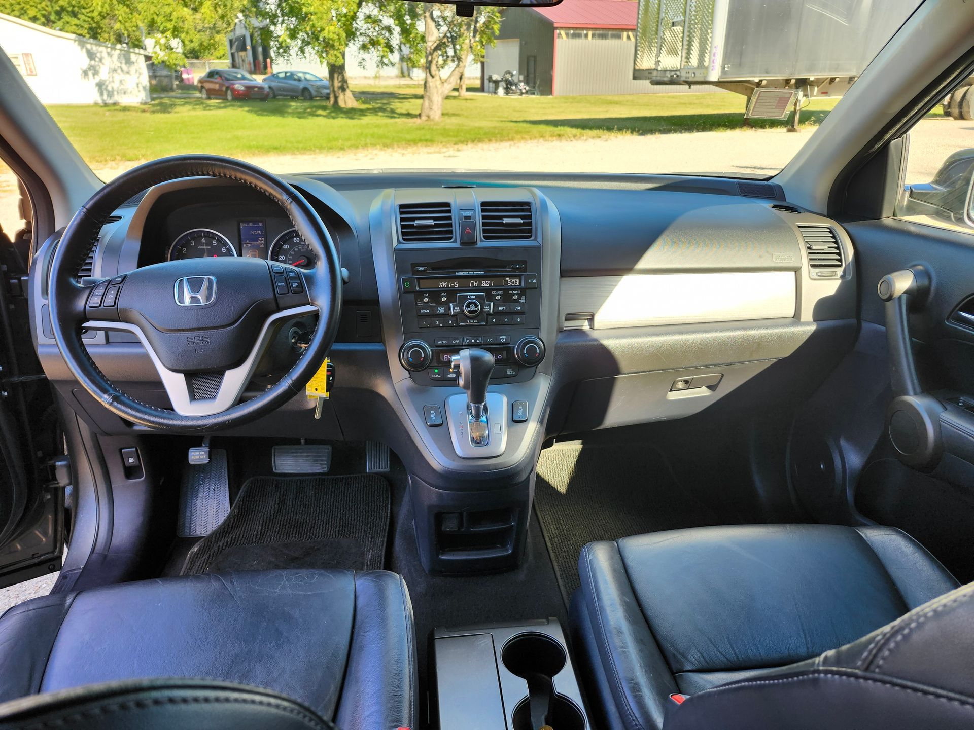 The interior of a honda cr v with a steering wheel and dashboard