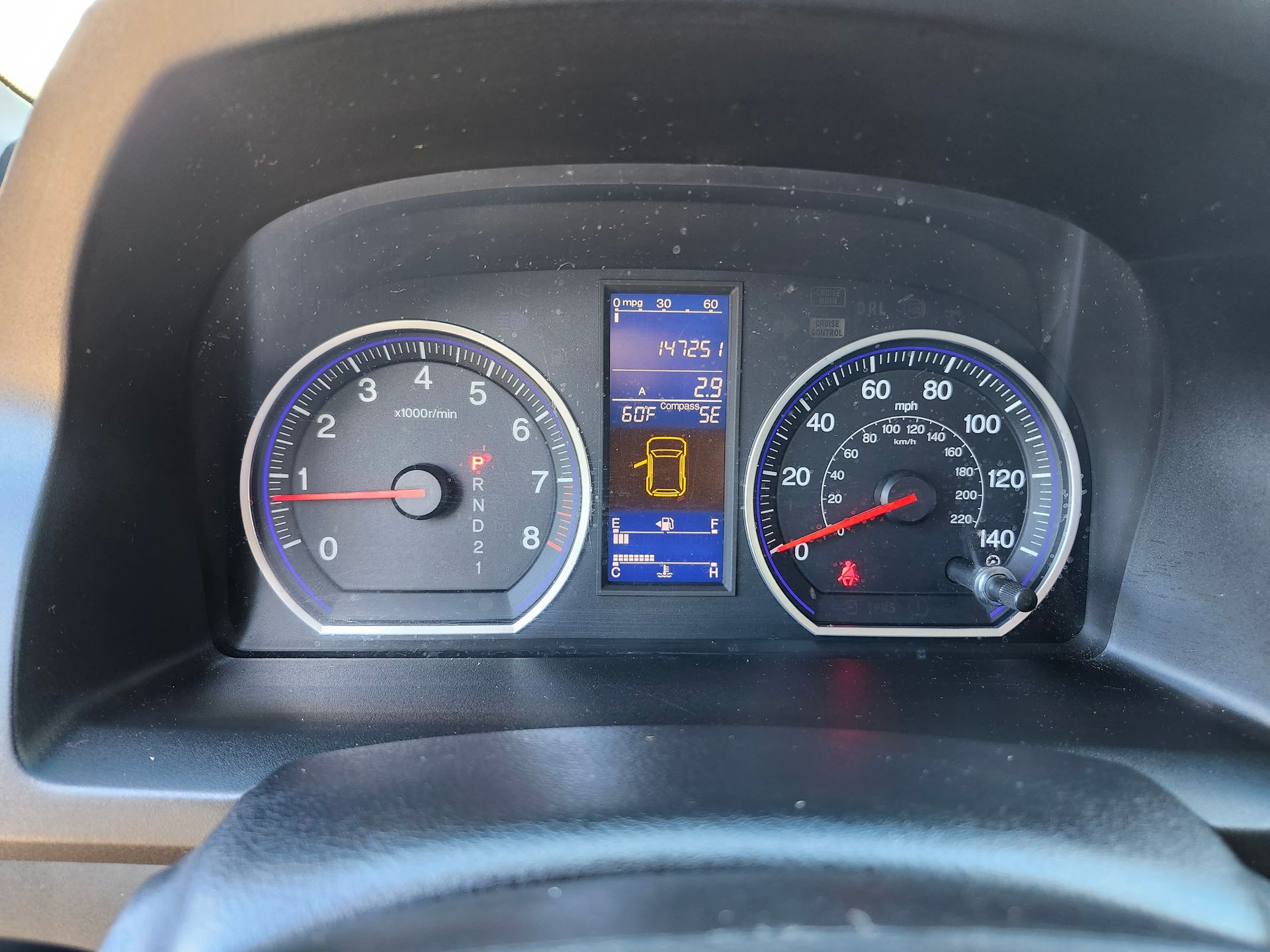 A close up of a car dashboard with the number 0 on it