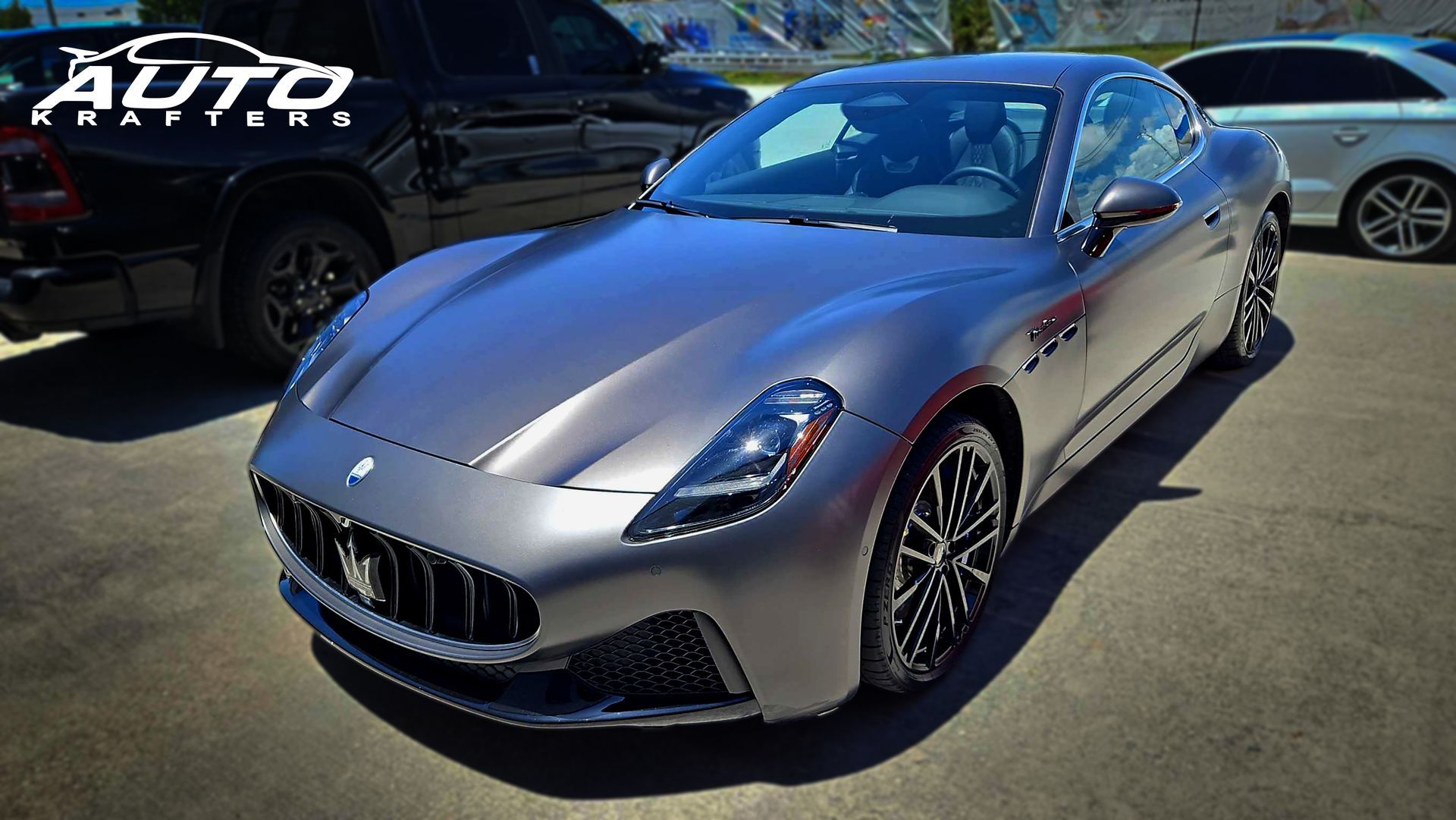 Gray Maserati GranTurismo coupe parked outdoors.