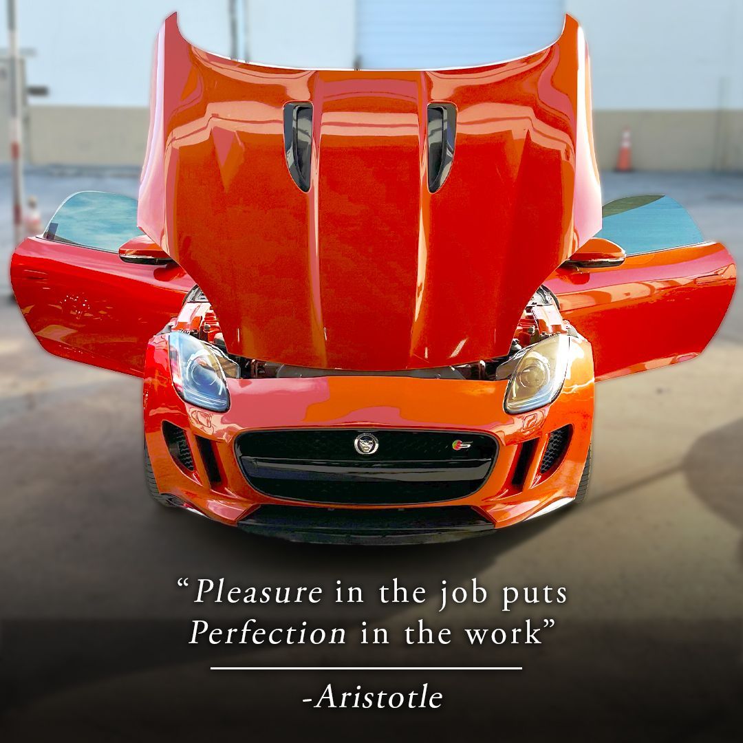 Orange Jaguar sports car with open hood and doors, quote by Aristotle.