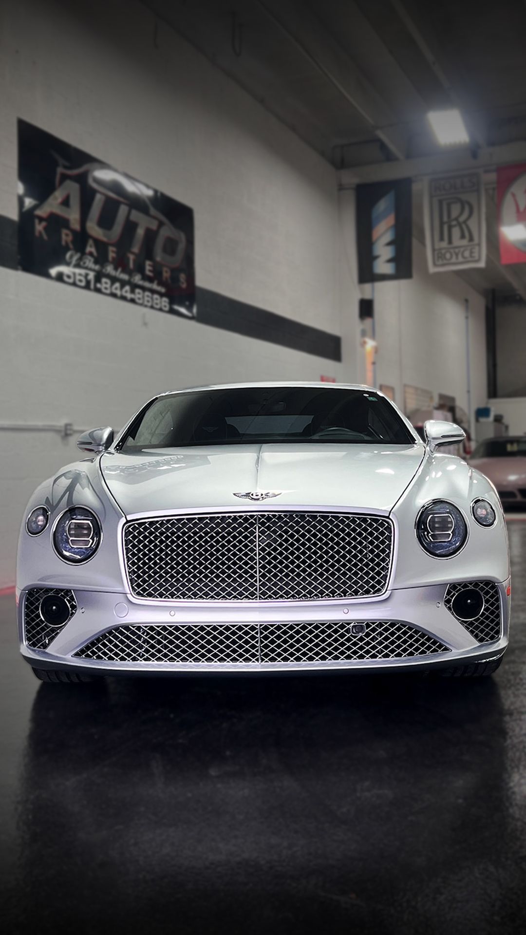 White Bentley in a showroom with the 