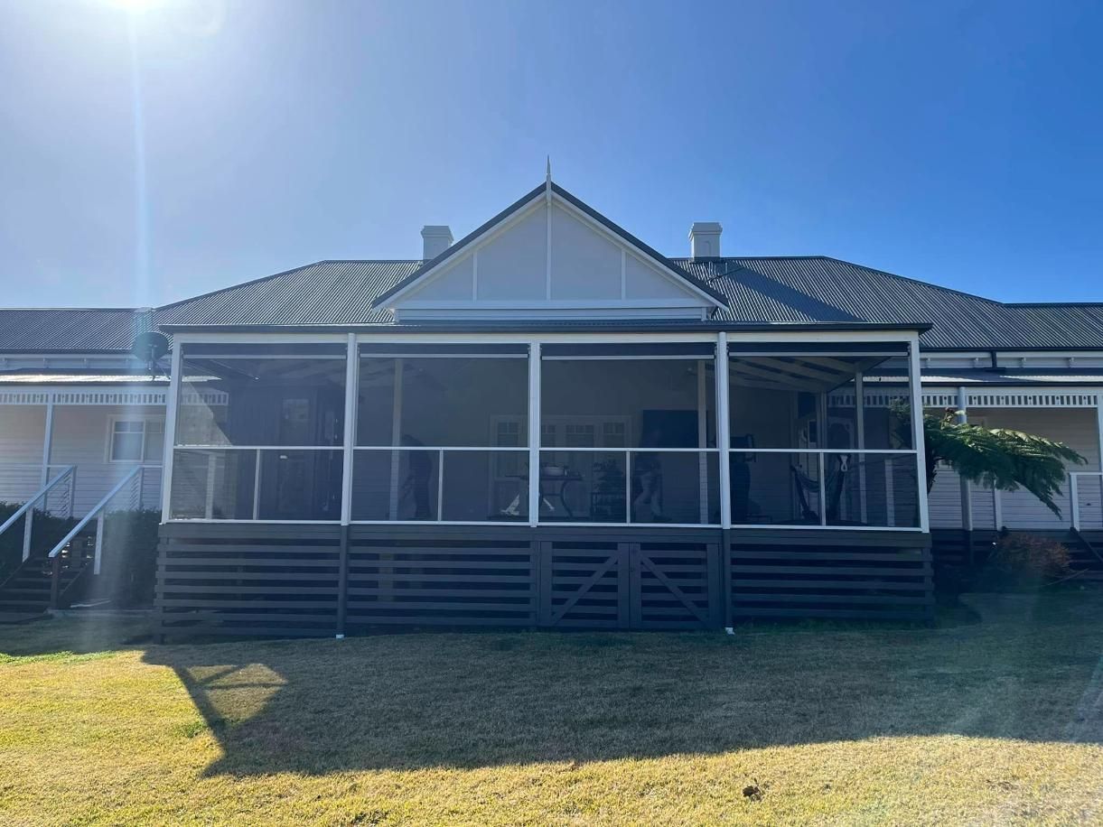 A Large White House With a Screened in Porch on a Sunny Day — Holster Painting Contractors In Port Macquarie, NSW