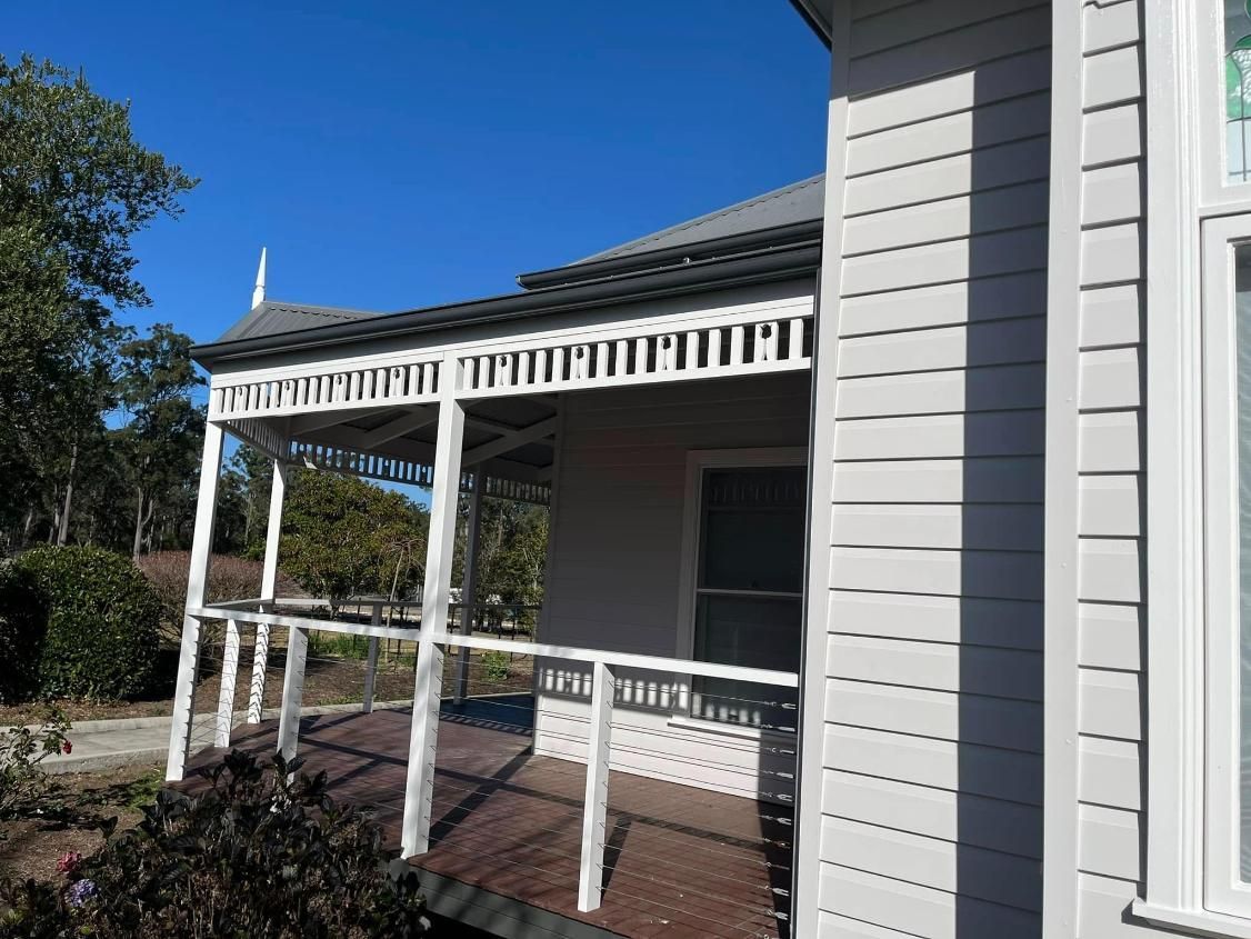 A White House With a Porch and a Walkway Leading to It — Holster Painting Contractors In Port Macquarie, NSW