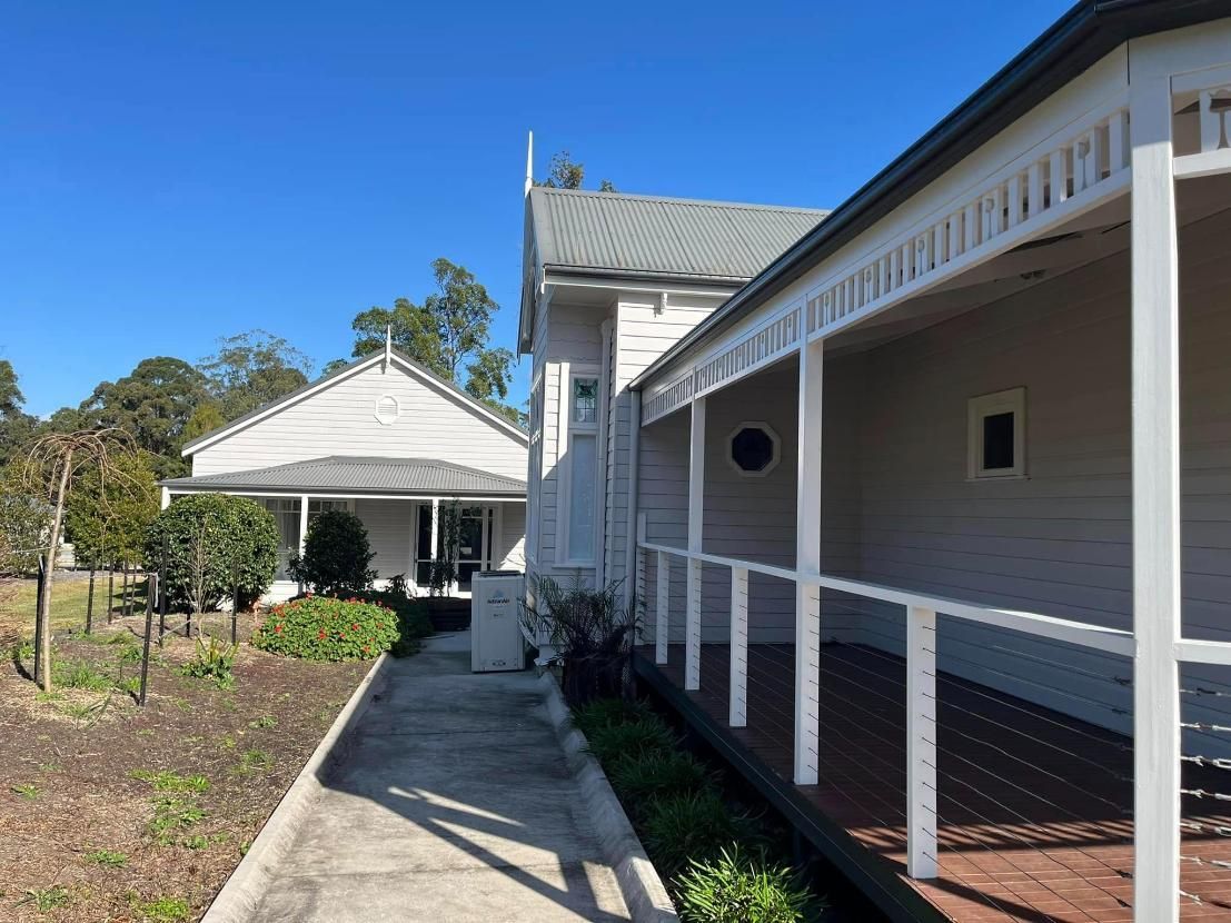 A White House With a Porch and a Walkway Leading to It — Holster Painting Contractors In Port Macquarie, NSW
