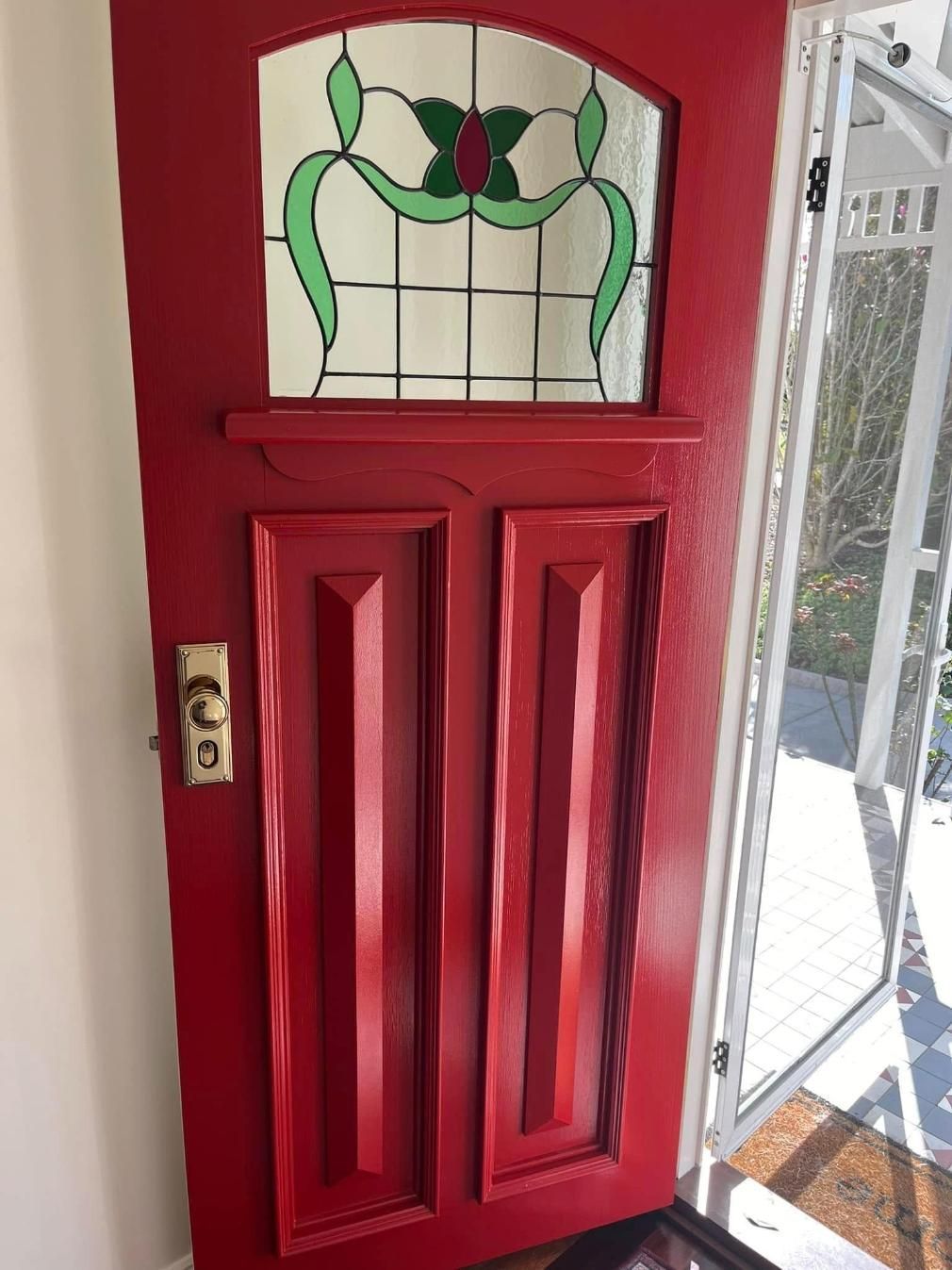 A Red Door With a Stained Glass Window is Sitting Next to a Window — Holster Painting Contractors In Port Macquarie, NSW