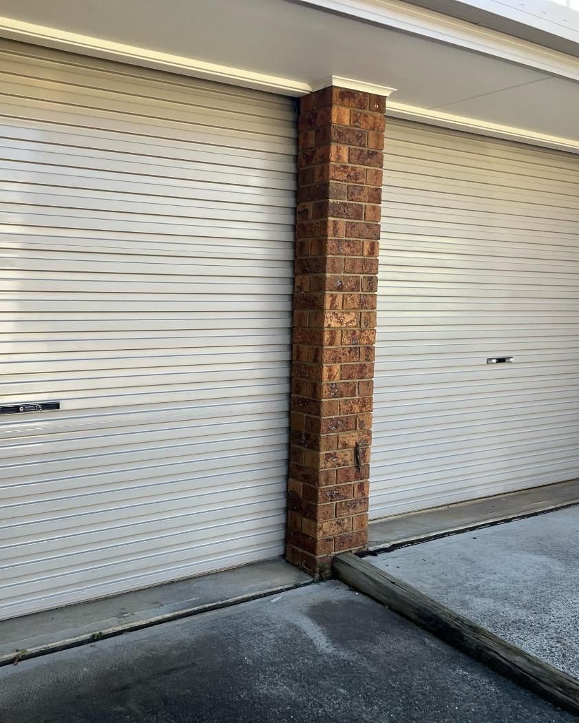 There is a Brick Column Between Two Garage Doors — Holster Painting Contractors In Port Macquarie, NSW