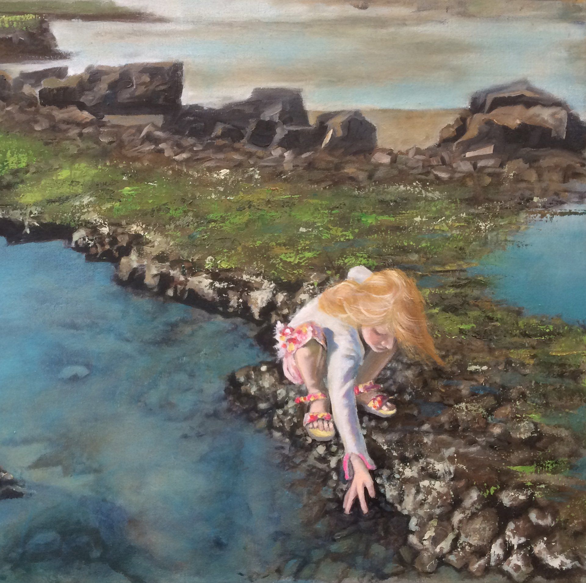 Young girl by rockpool