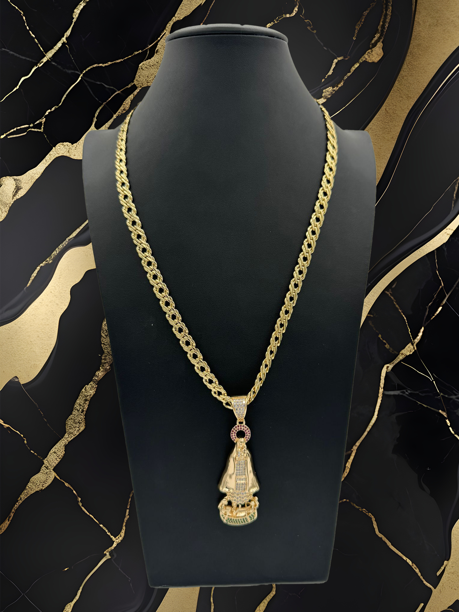 A gold necklace with a pendant on a mannequin.