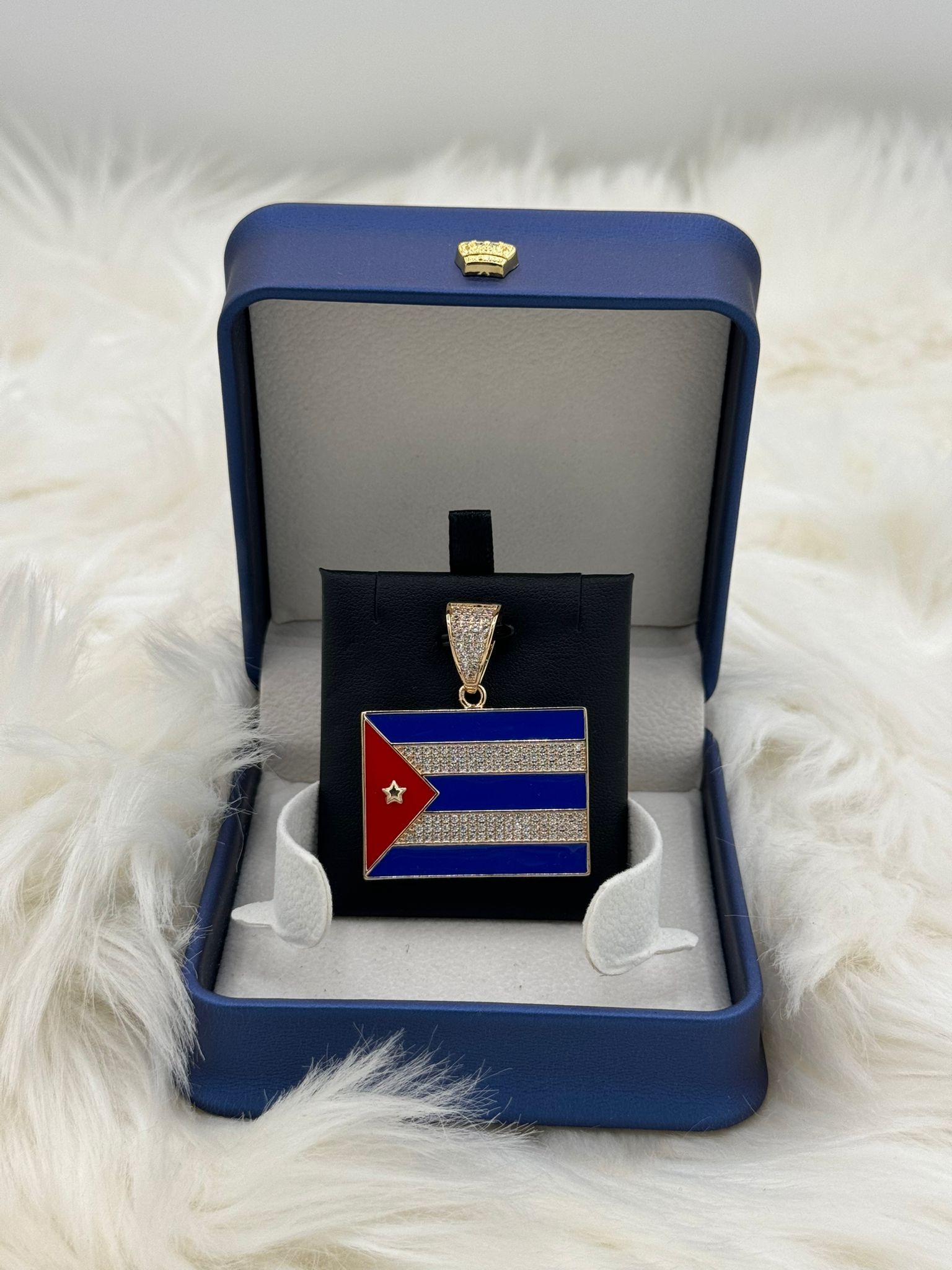 A pendant in a blue box with a cuban flag on it