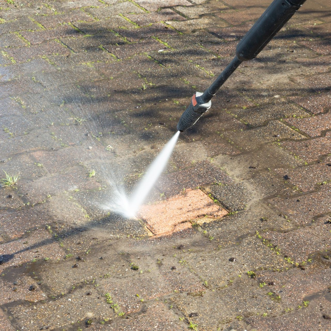 A green trash can with a piece of paper in it.