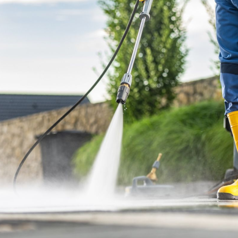 A green trash can with a piece of paper in it.