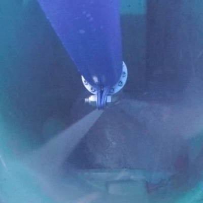 A green trash can with a piece of paper in it.