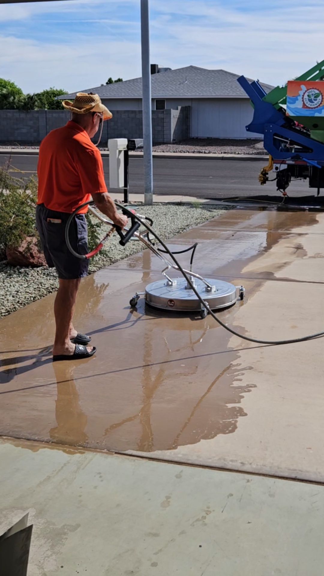 A green trash can with a piece of paper in it.