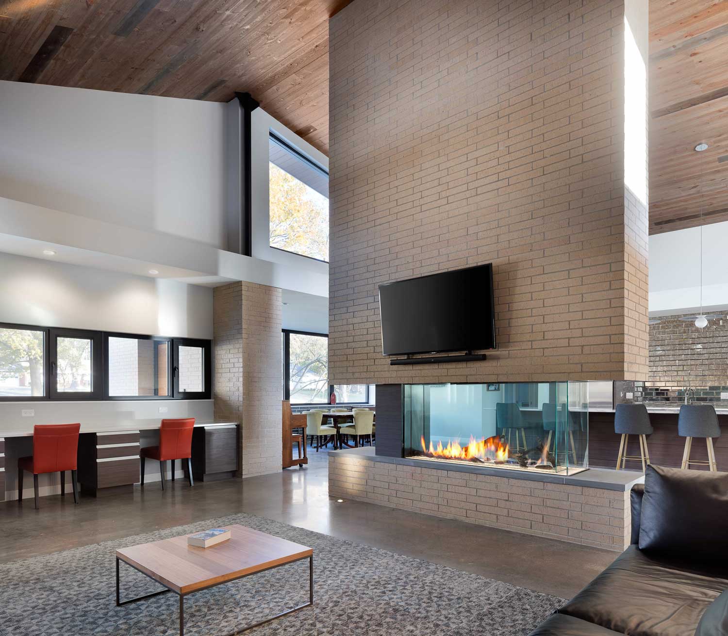 Large modern fireplace separating two living spaces