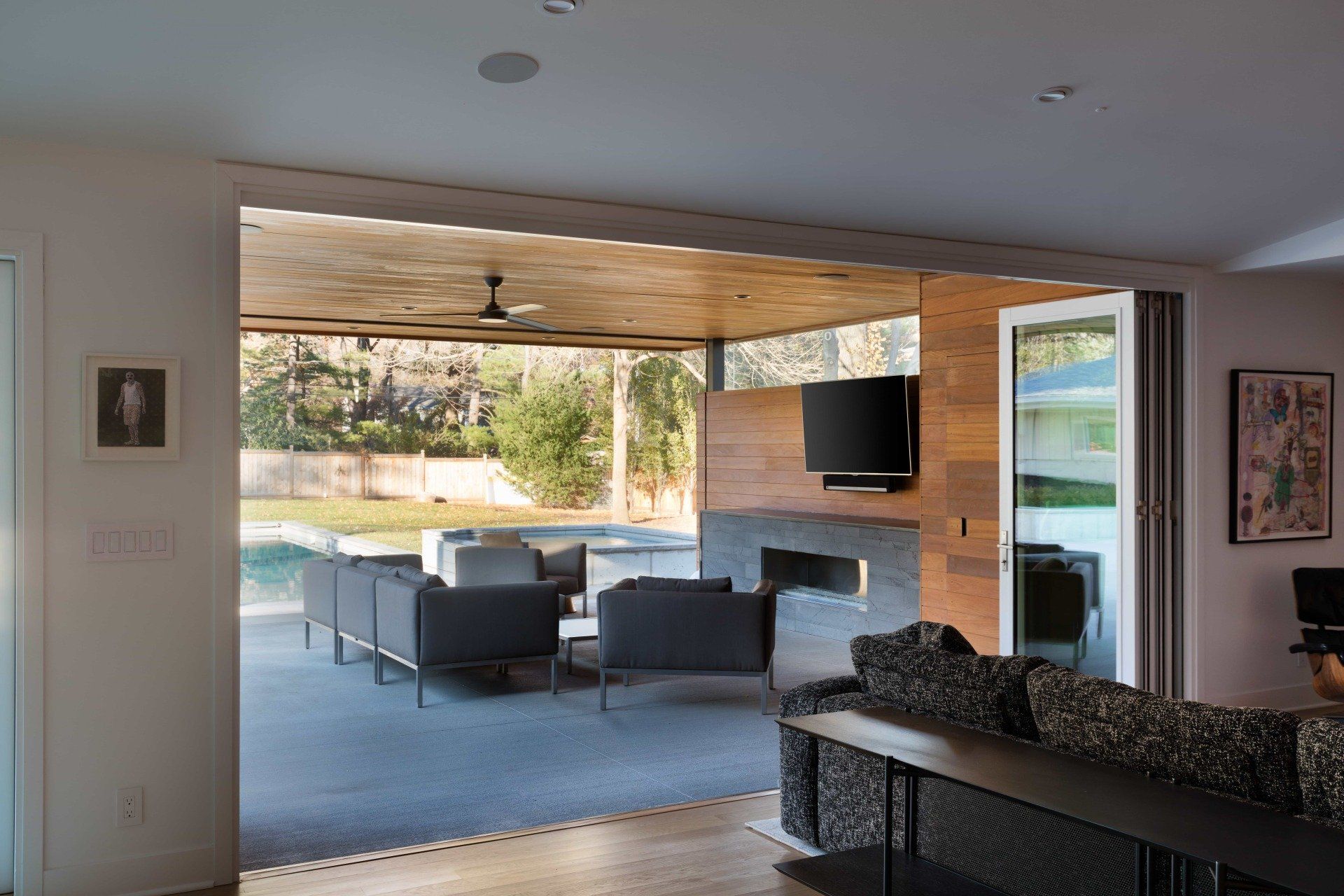 Indoor/outdoor living space with retracting wall door system
