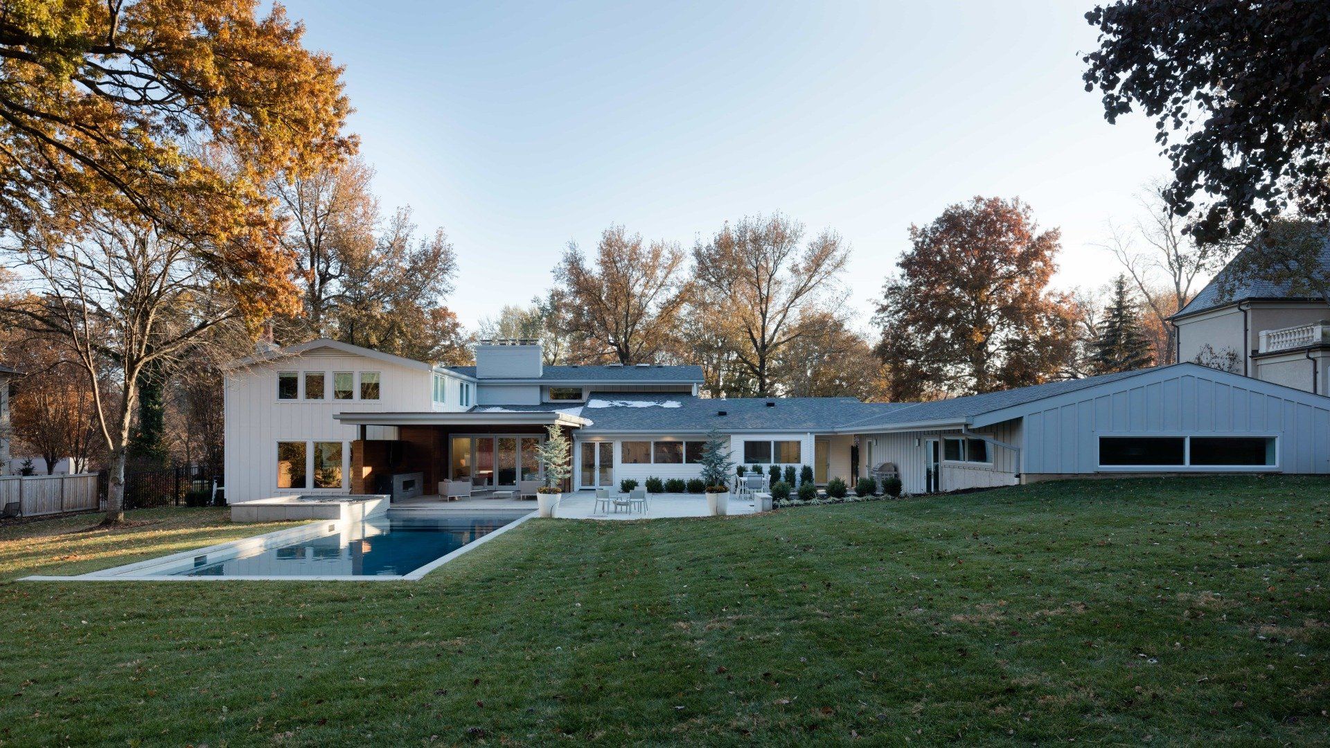 Backyard of updated mid-century home with pool, hot tub, and outdoor living area