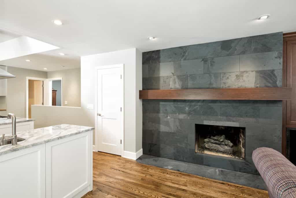 Custom stone fireplace near kitchen