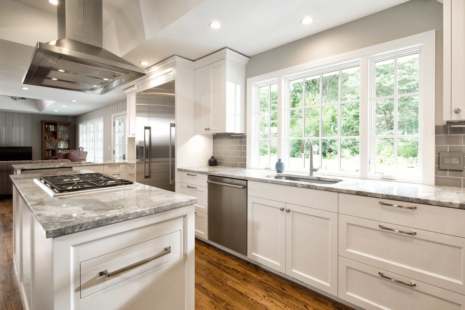 Updated kitchen with white cabinetry and large  island