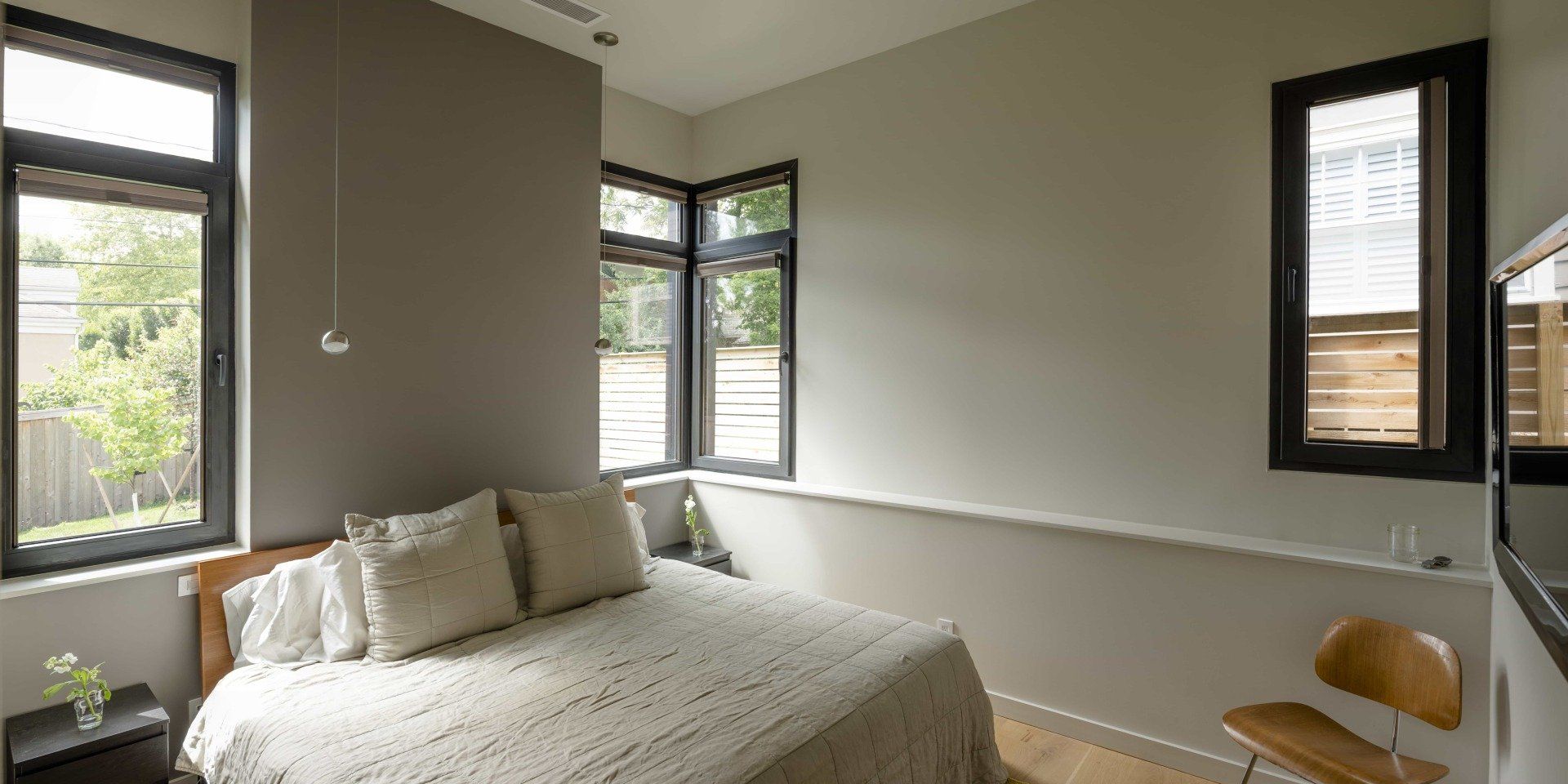 Large modern bedroom with queen size bed and bright light