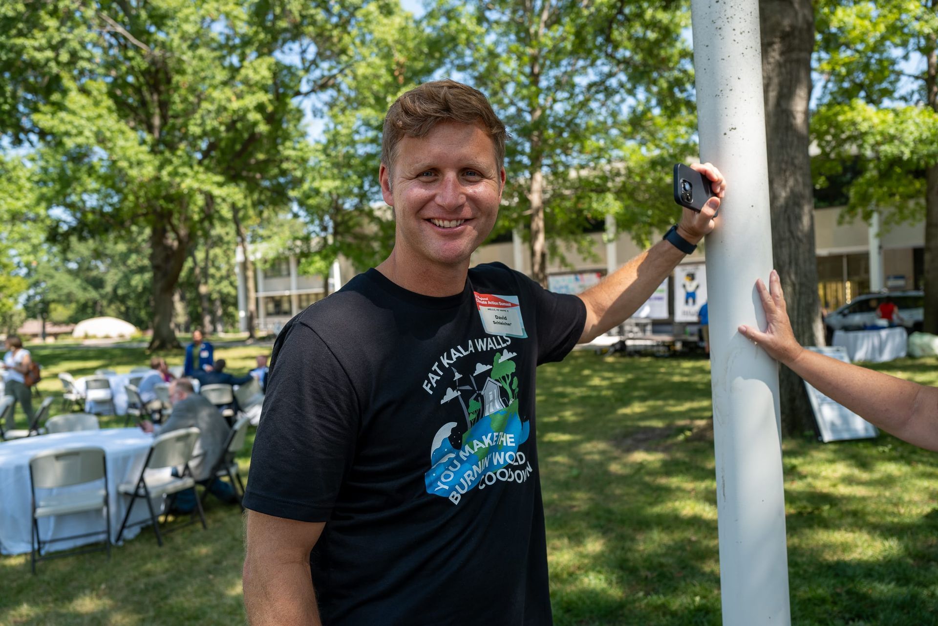 David Schleicer smiling while wearing a Kala shirt at the Climate Action Expo
