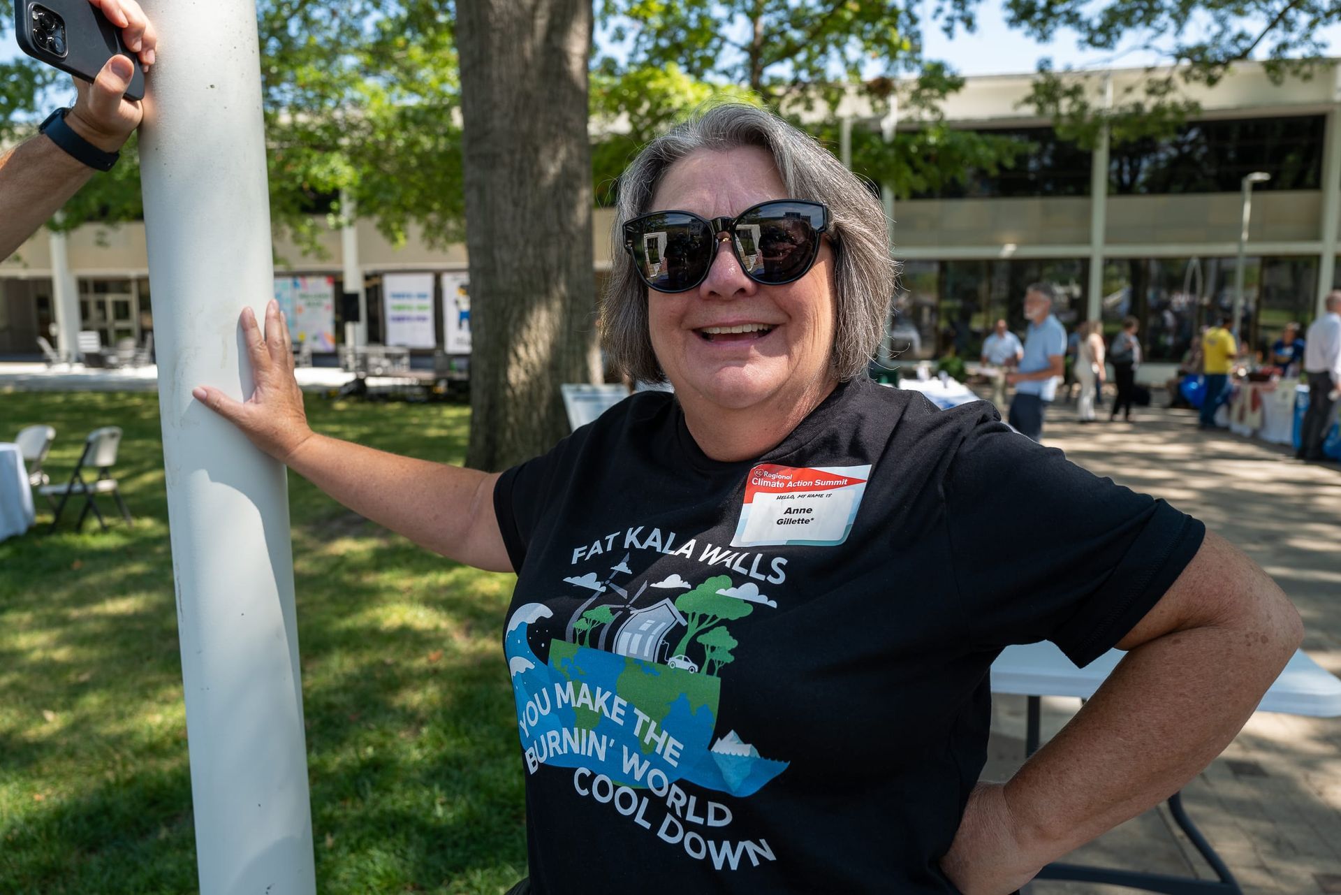 Anne Gillette smiling while wearing a Kala shirt at the Climate Action Expo