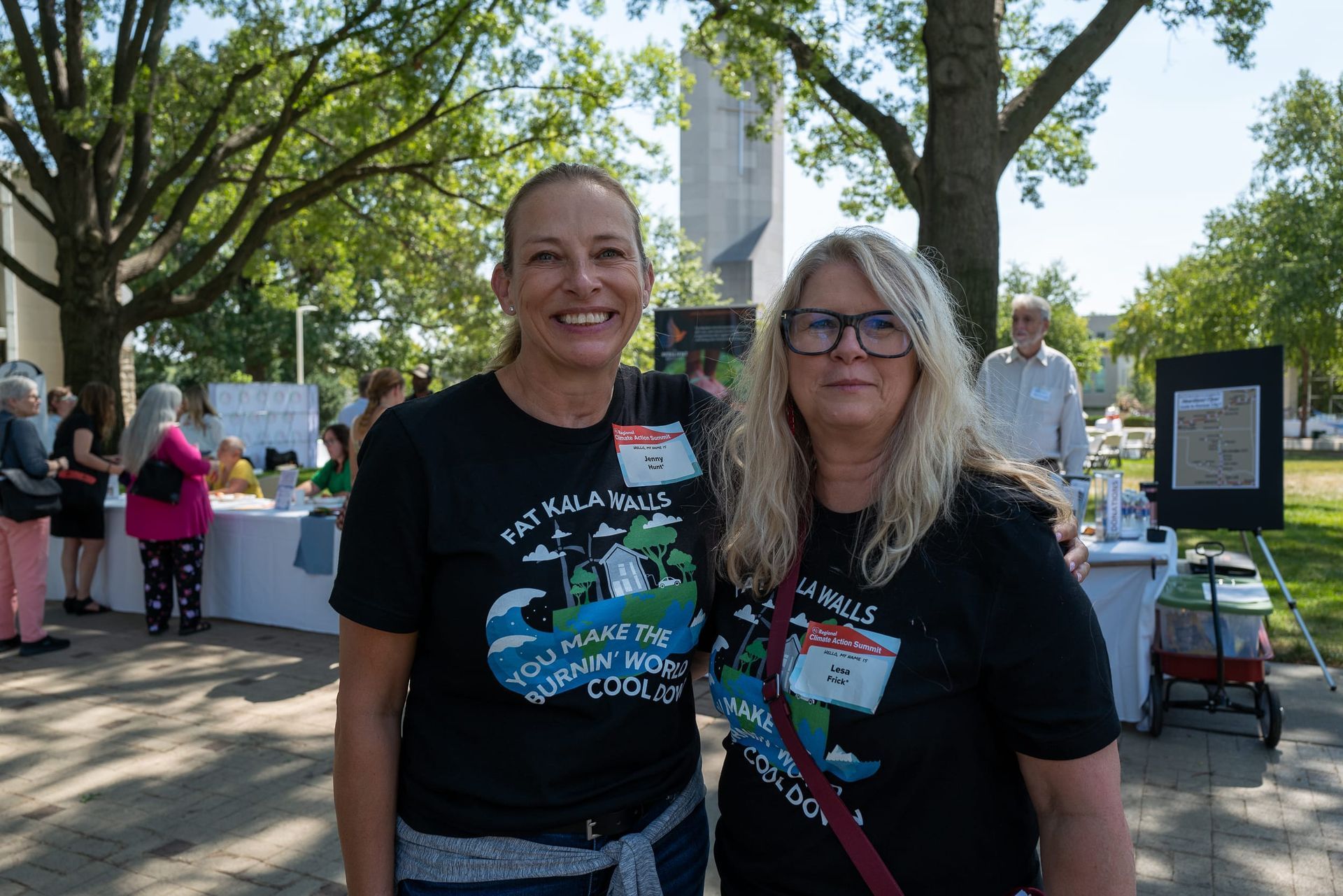 Two smiling Kala team members wearing matching Kala shirts
