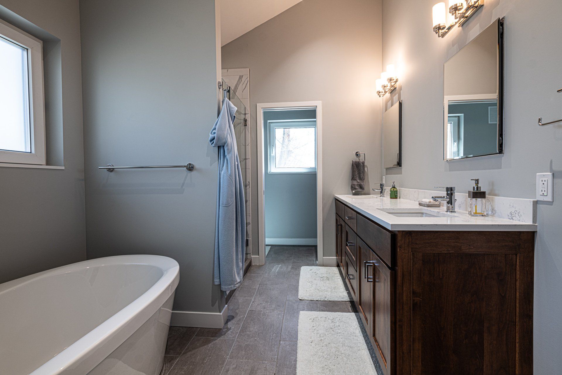 Primary bathroom suite with white tub and natural light.