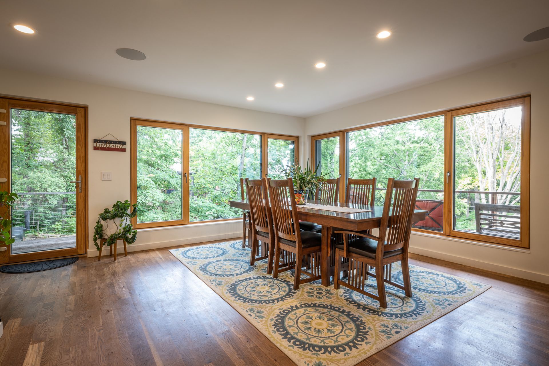 Dining room table surrounded by large windows