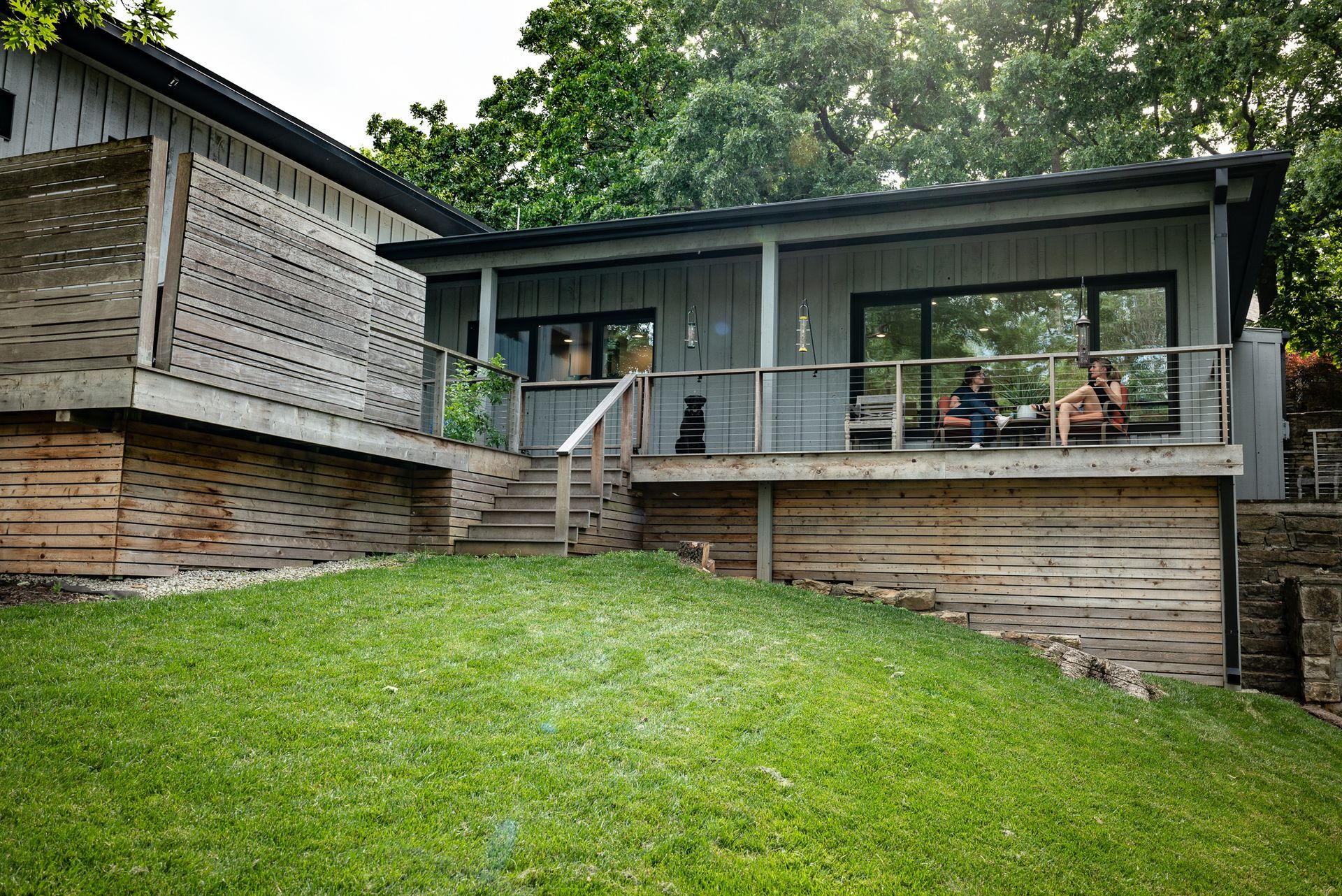Exterior shot of grey mid-century modern home on a hill