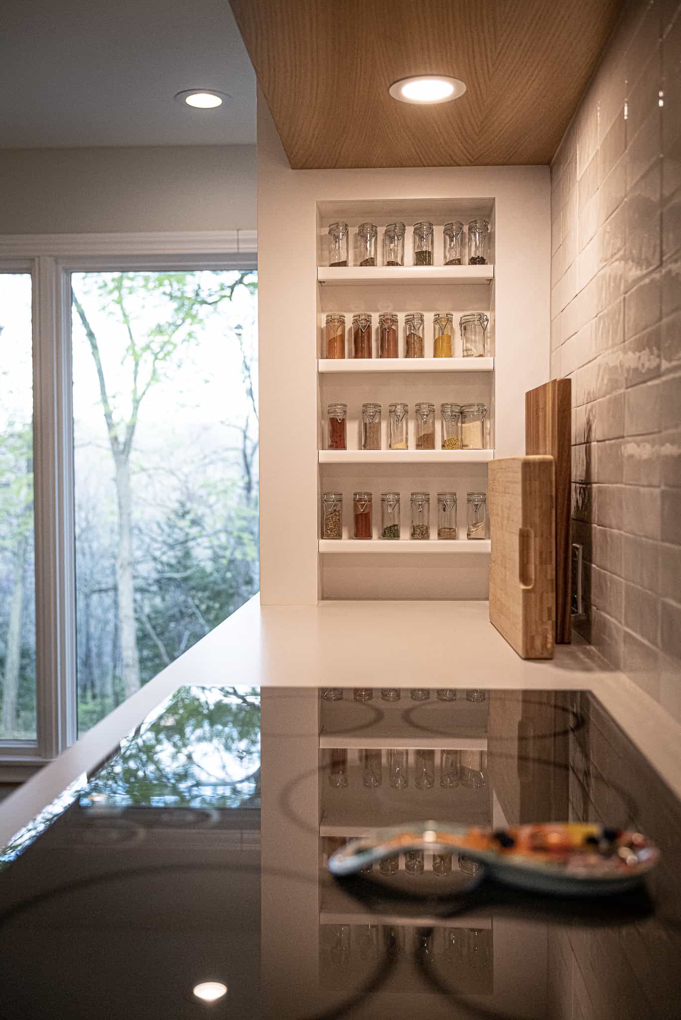 Clean and organized spice rack and kitchen stovetop.