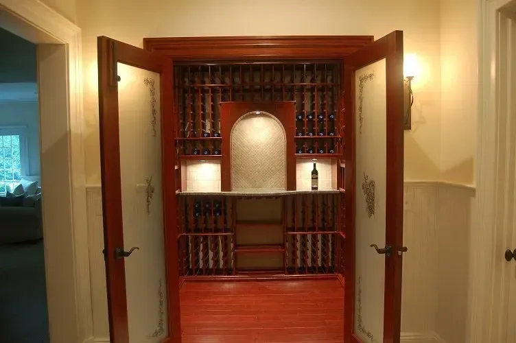 Wine storage cabinet with open doors, wooden racks, and built-in lighting.